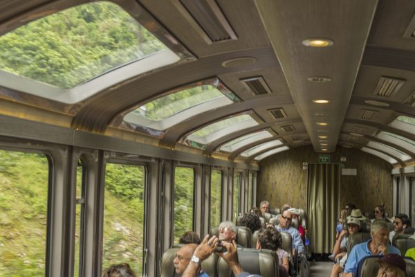 Tourist traveling in the panoramic Hiram Bingham train to Aguas Calientes in Perú. The town is the closest human settlement to the ancient Incan city of Machu Picchu and has become a tourist hub for visitors wishing to visit the famous Incan city.