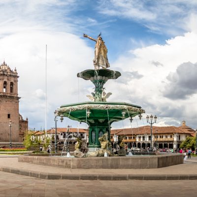 Panoramic view of Plaza de Armas with Inca fountain, Cathedral and Compania de Jesus Church - Cusco, Peru