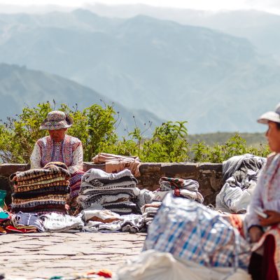 Arequipa, Peru - February 5, 2018: Two street vendor women offer souvenirs in the Colca Canyon, in the province of Arequipa